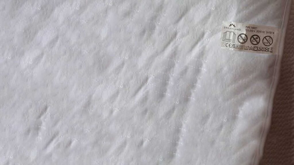Look at the mattress pad tag before putting in the washer.